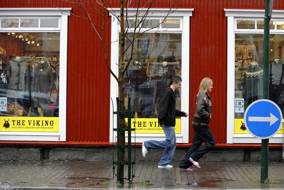 Week in Business: Teenagers run in front of a store in Reykjavik centre.