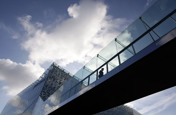 Week in Business: A shopper leaves a John Lewis store in Leicester
