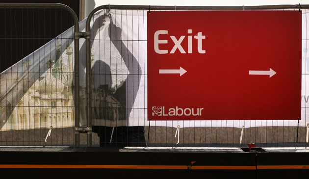 Labour conference 5: A workman removes Labour party signage from the Brighton Centre