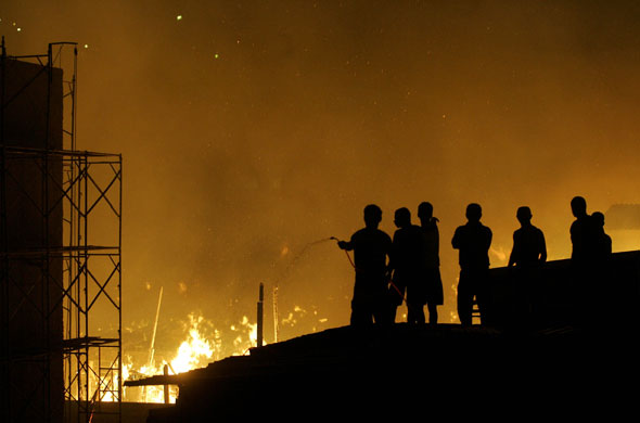 Sao Paulo Brazil fire: Residents spray water during a fire in Sao Paulo