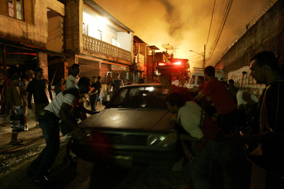 Sao Paulo Brazil fire: People try to save a car from the flames 