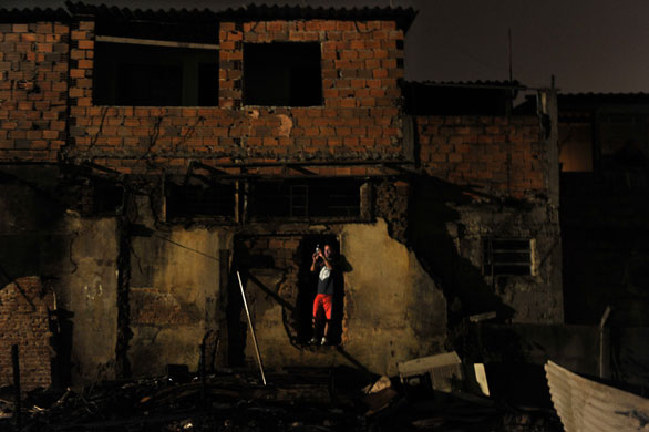 Sao Paulo Brazil fire: A resident takes a photograph with his mobile phone of firefightters