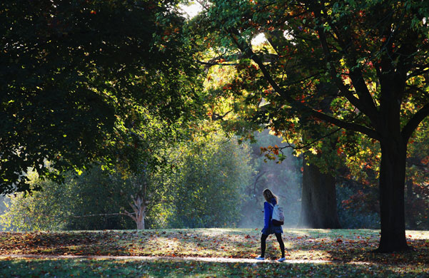 Autumn: A woman walks through Victoria Park in Bath