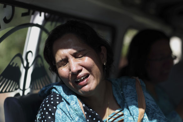 Pakistan: 5 October 2009: A woman cries next to the body of suicide attack victim