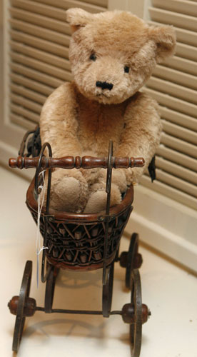 Barbra Streisand auction: A wicker doll carriage with a teddy bear