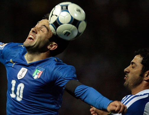 world cup qualifiers: Italy's Rossi jumps for the ball with Cyprus' Okkas 
