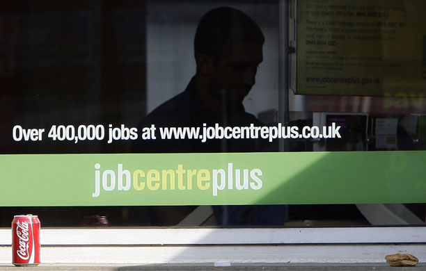 Week in Business: A man looks at literature in a job centre in Leicester