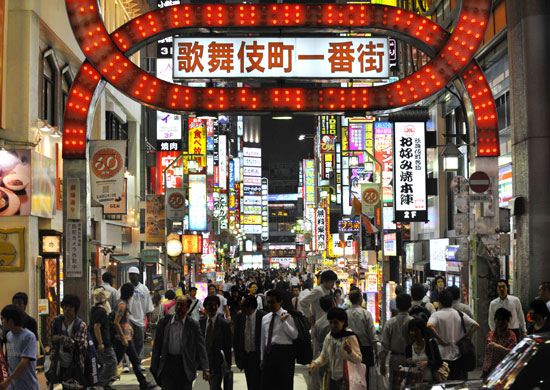 Week in Business: People walk through Shinjuku's Kabuki-cho district of Tokyo, Japan