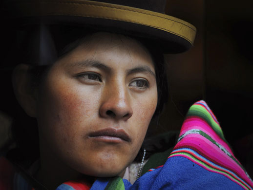 24 hours in pictures: A Bolivian woman attends an indigenous meeting in Cochabamba