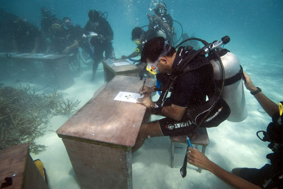 24 hours in pictures: Maldivian government ministers in scuba gear hold an underwater meeting