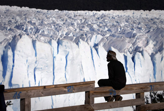 24 hours in pictures: A man sits in front of Argentina's Perito Moreno glacier