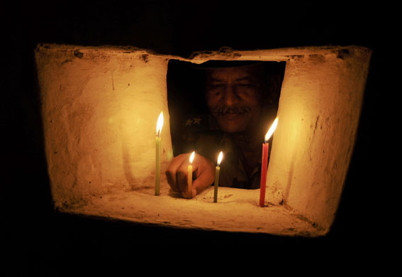 Diwali: An Indian BSF soldier lights a candle