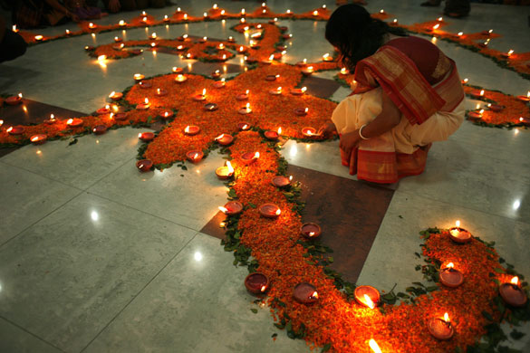Diwali: A Hindu woman lights candles in a temple in Dhaka, Bangladesh