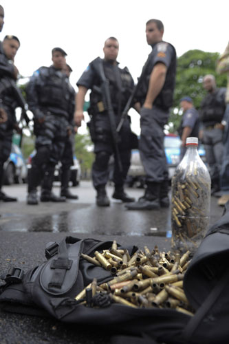 Rio de Janeiro: Police officers show bullet capsules found at the slum