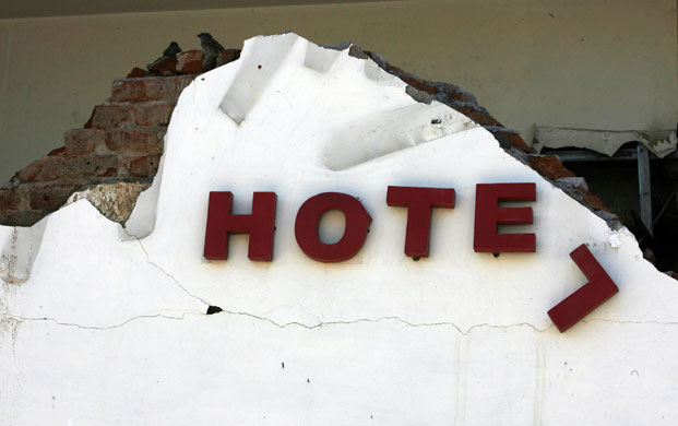 Sumatra earthquake: A destroyed sign is seen at the Ambacang Hotel