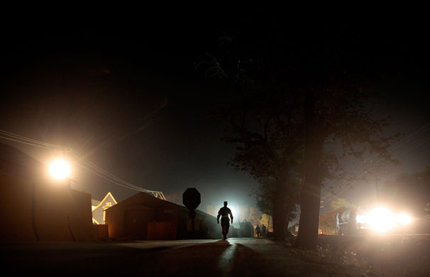2 October 2009: Bagram, Afghanistan: A soldier walks along Disney Road