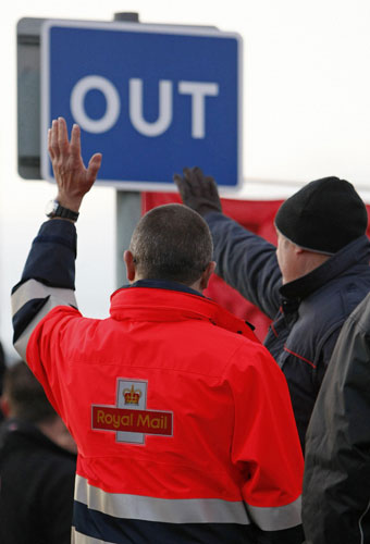 Postal strike: Manchester: Postal workers wave to passing motorists 