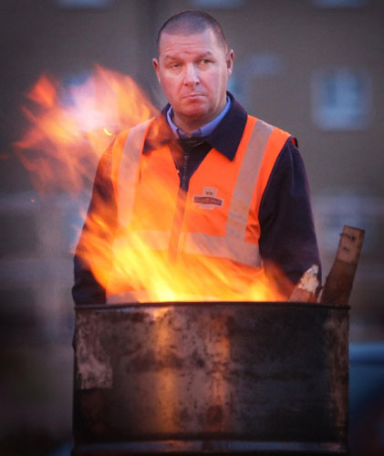 Postal strike: Glasgow: A striking worker stands outside the Royal Mail's sorting centre
