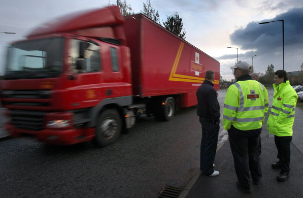 Postal strike: Bristol: Striking postal workers watch a lorry pass on a picket line