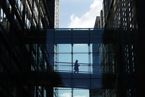 Week in Business: A woman crosses a walkway between Goldman Sachs offices in London