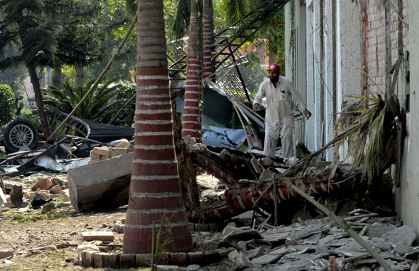 more bombings in pakistan: A Pakistani security official at a bomb blast site in Peshawar