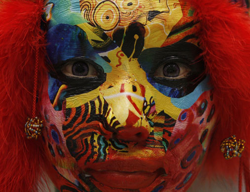 24 hours: A woman with stickers pasted over on her face poses at Design Festa Tokyo