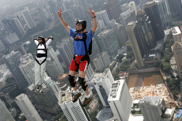24 hours: Kuala Lumpur, Malaysia: Base jumpers leap from the landmark KL Tower 