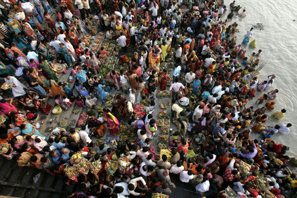 24 hours: Hindu devotees on the banks of the River Ganges during the Chhath festival