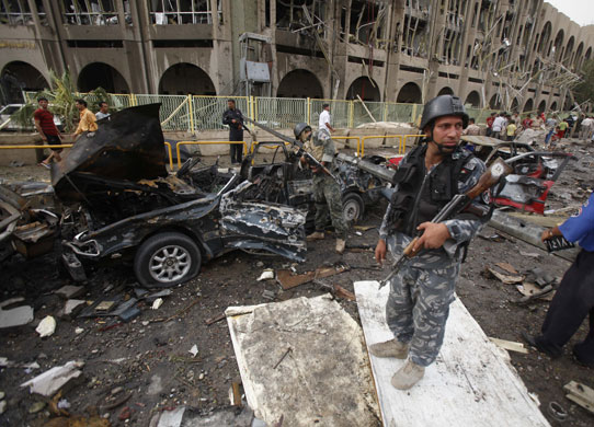 Bomb in Baghdad: Iraqi security forces inspect the site of a massive bomb attack