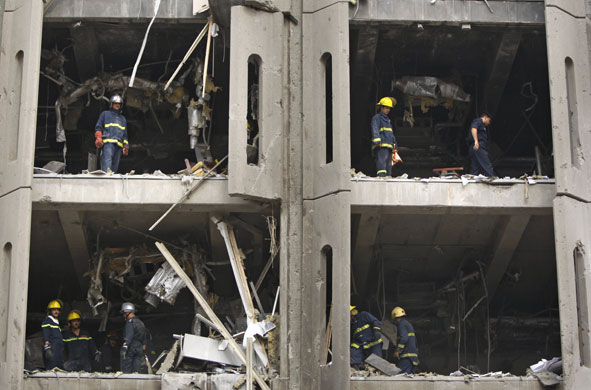 Bombs in Baghdad: Iraqi firemen work in blown out offices following a suicide bombing 