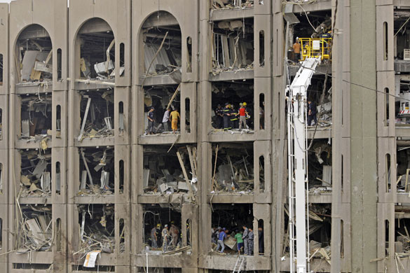 Bombs in Baghdad: Iraqis inspect the badly damaged Ministry of Justice in Baghdad