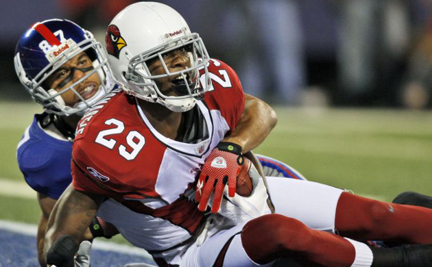 <b>Arizona Cardinals 24, New York Giants 17: </b>  Giants wide receiver Domenik Hixon, left, tackles Cardinals cornerback Dominique Rodgers-Cromartie after Rodgers-Cromartie intercepted a pass by Giants quarterback Eli Manning. The Cardinals (4-2) forced four turnovers as the defending NFC champions moved into first place in the West division. The Giants (5-2) lost their second game in a row