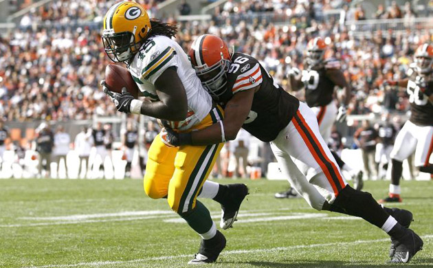 <b>Green Bay 31, Cleveland Browns 3:</b> Quinn Johnson of the Packers makes a catch as he is hit by David Bowens of the Browns. Packers quarterback Aaron Rodgers threw three touchdown passes as Green Bay (4-2) added to the Browns' (1-6) woes this season. On Green Bay's first offensive series, Rodgers was punched in the face after a Browns player ripped his helmet off. Rodgers maintained his composure after the incident, passing for 246 yards
