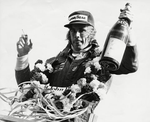 British Grand Prix: James Hunt celebrates his 1977 British GP win with champagne & a cigarette