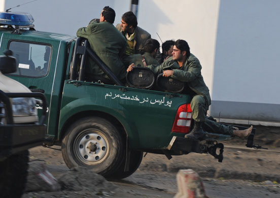 kabul attacks: police take a casualty away from Bekhtar guesthouse ,kabul