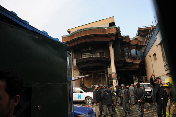 kabul attacks: Afghan policemen inspect the Bekhtar guesthouse in Kabul