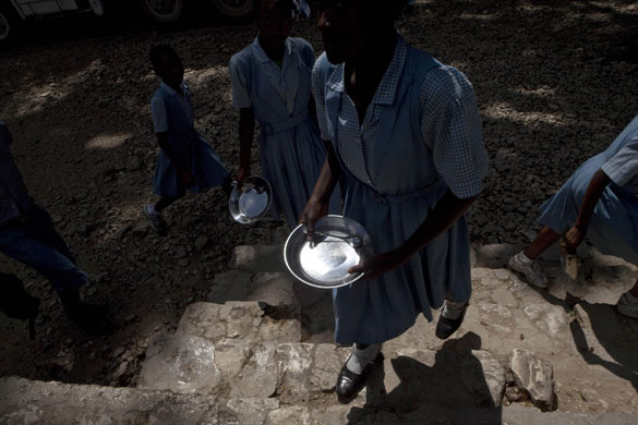 24 hours in pictures: Chauffard, Haiti: School girls hold empty plates