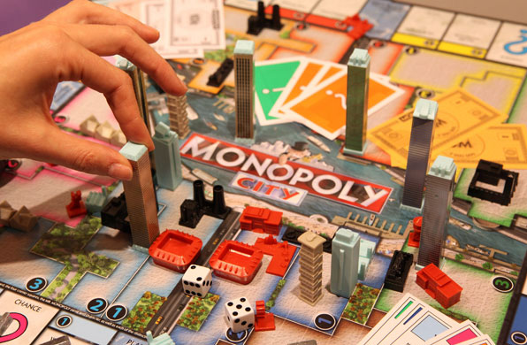 Top toys: A woman positions a tower block in the Monopoly City board game