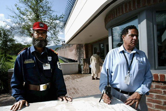 US embassies: Security guards monitor the main entry gate at the US embassy in Islamabad