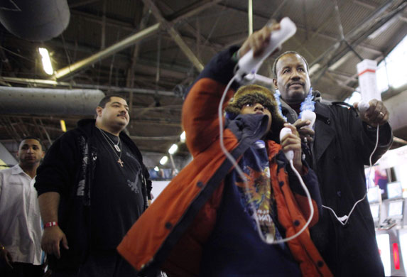 Week in business: A boy tries out a Wii game at the Big Apple Comic Con in New York