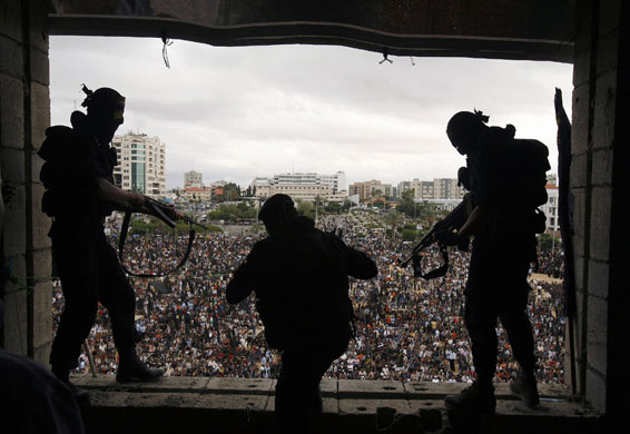 24 hours in pictures: Islamic Jihad militants stand guard during an anti-Israel rally in Gaza