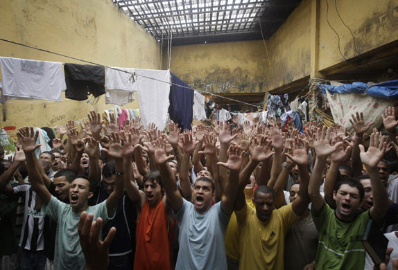 24 hours in pictures: Prisoners attend a cult meeting held by an Evangelical pastor