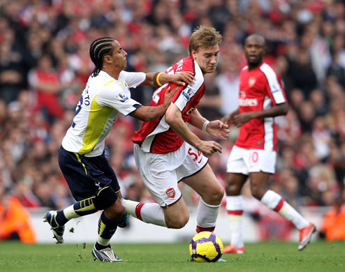 Arsenal v Tottenham: Nicklas Bendtner barges past Benoit Assou-Ekotto