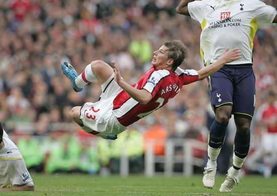 Arsenal v Tottenham: Andrey Arshavin goes flying after taking a shot 