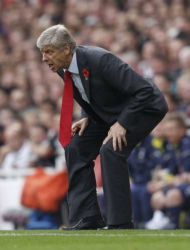 Arsenal v Tottenham: Arsenal manager Arsene Wenger urges his side on from the touchline