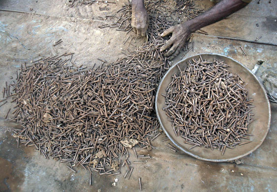 24 hours : A labourer works at an automobile junk market in New Delhi