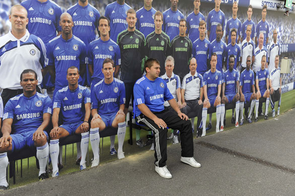 Chelsea v Liverpool : A Chelsea fan poses with a wall plastered with the team photo