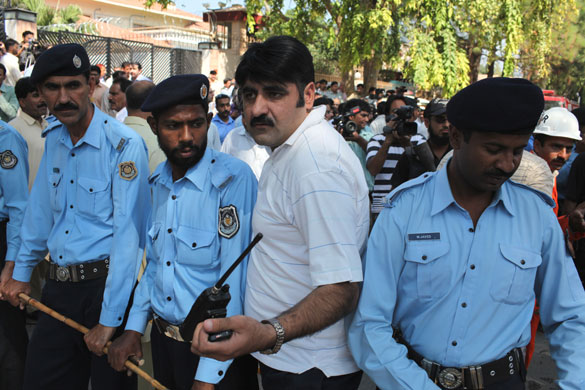 Islamabad bomb: Police and security services outside the sandbagged front wall
