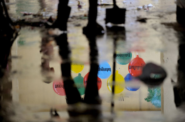 5 October 2009: Manila, Philippines: A student uses a shovel to clean a hallway