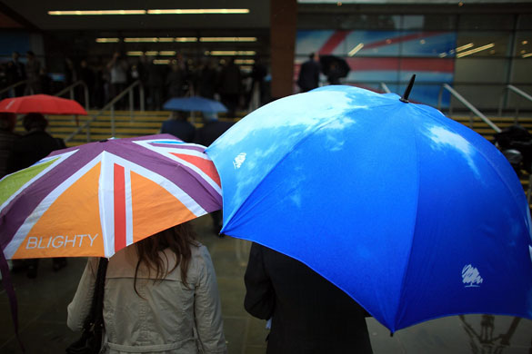Conservative conference 2: Delegates walk through the rain 